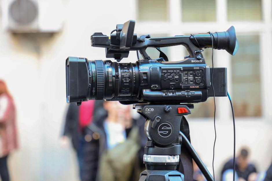 Professional video camera set up on a tripod to record a special event
